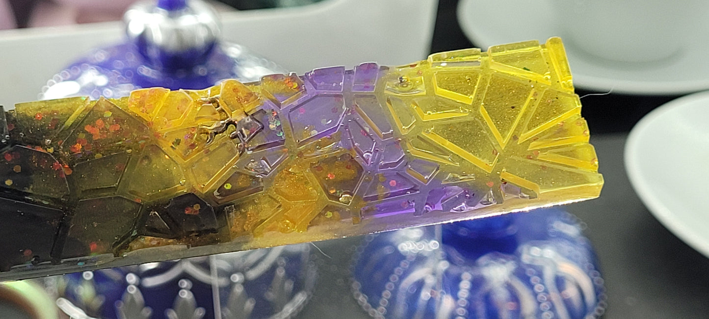 Colourful resin bookmark with a geometric design on a reflective surface