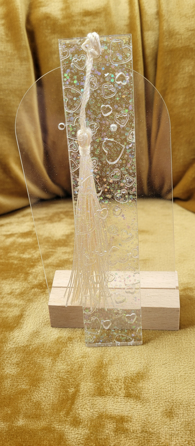 Clear rectangular bookmark with indented hearts, and embedded glitter.