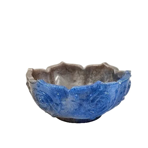 Decorative blue and silver flower-shaped  resin bowl showing off the blue half.