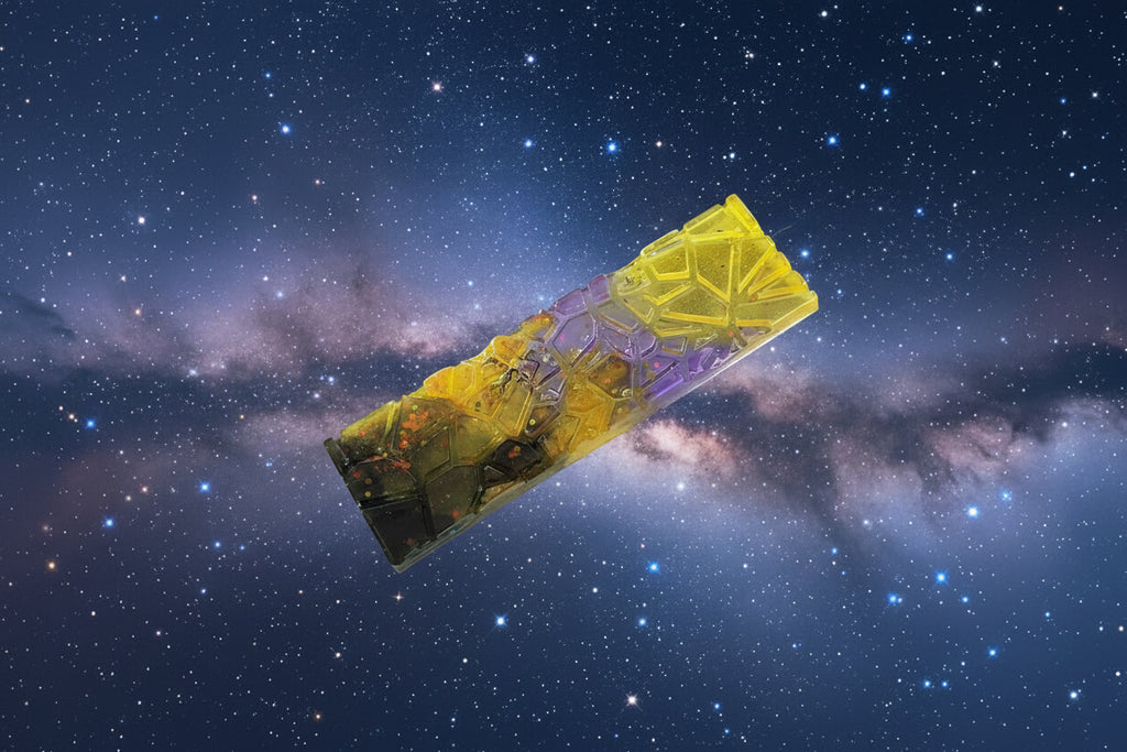 Colourful resin bookmark with a galaxy-themed design, with a starry night sky background